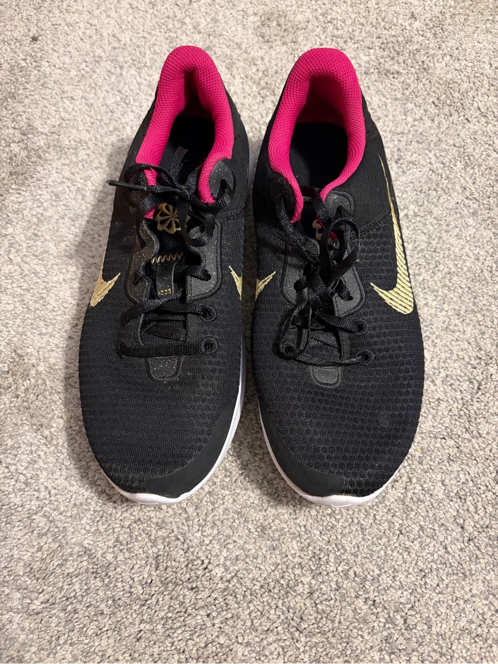 Nike Black Athletic Sneakers with Pink Lining and Gold Swoosh